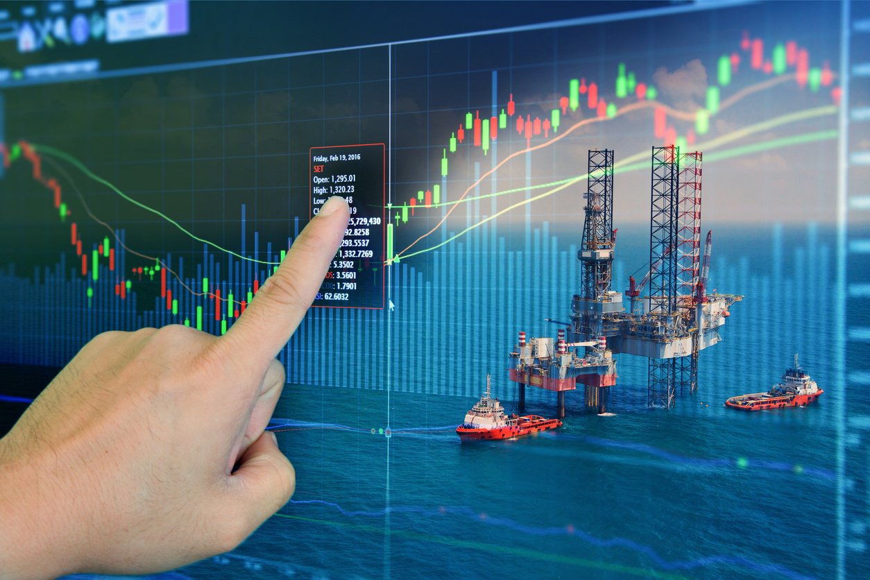 Stock market concept with oil rig in the gulf to highlight oil and gas exploration.